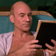 Jean-Luc Picard reads a book in an open robe.